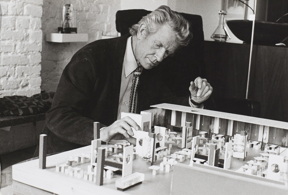 Robin Day with model of John Lewis restaurant, 1973